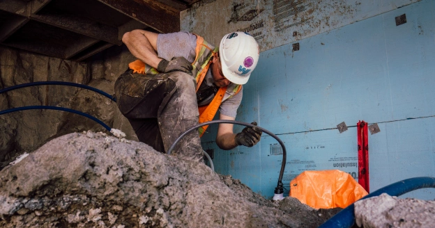 Worker checking pipes on construction site