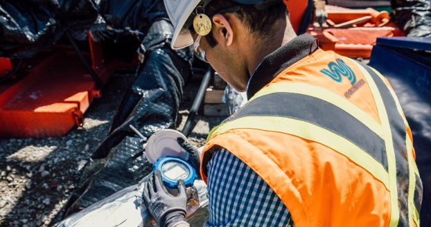 Worker checking reading meter on site