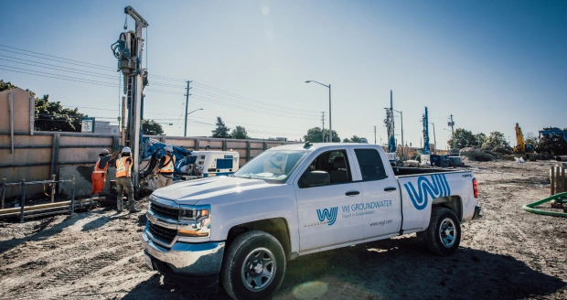 Drilling equipment and construction site with WJ Groundwater vehicle for geotechnical and groundwater services at WJ Middle East.